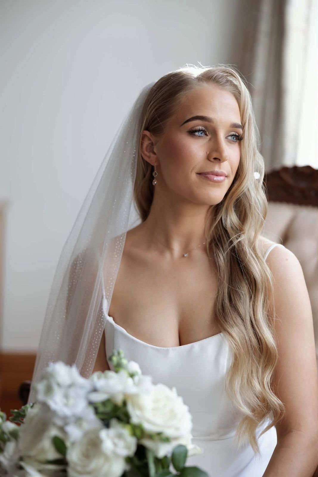 Bride in a veil with soft, glowing bridal makeup