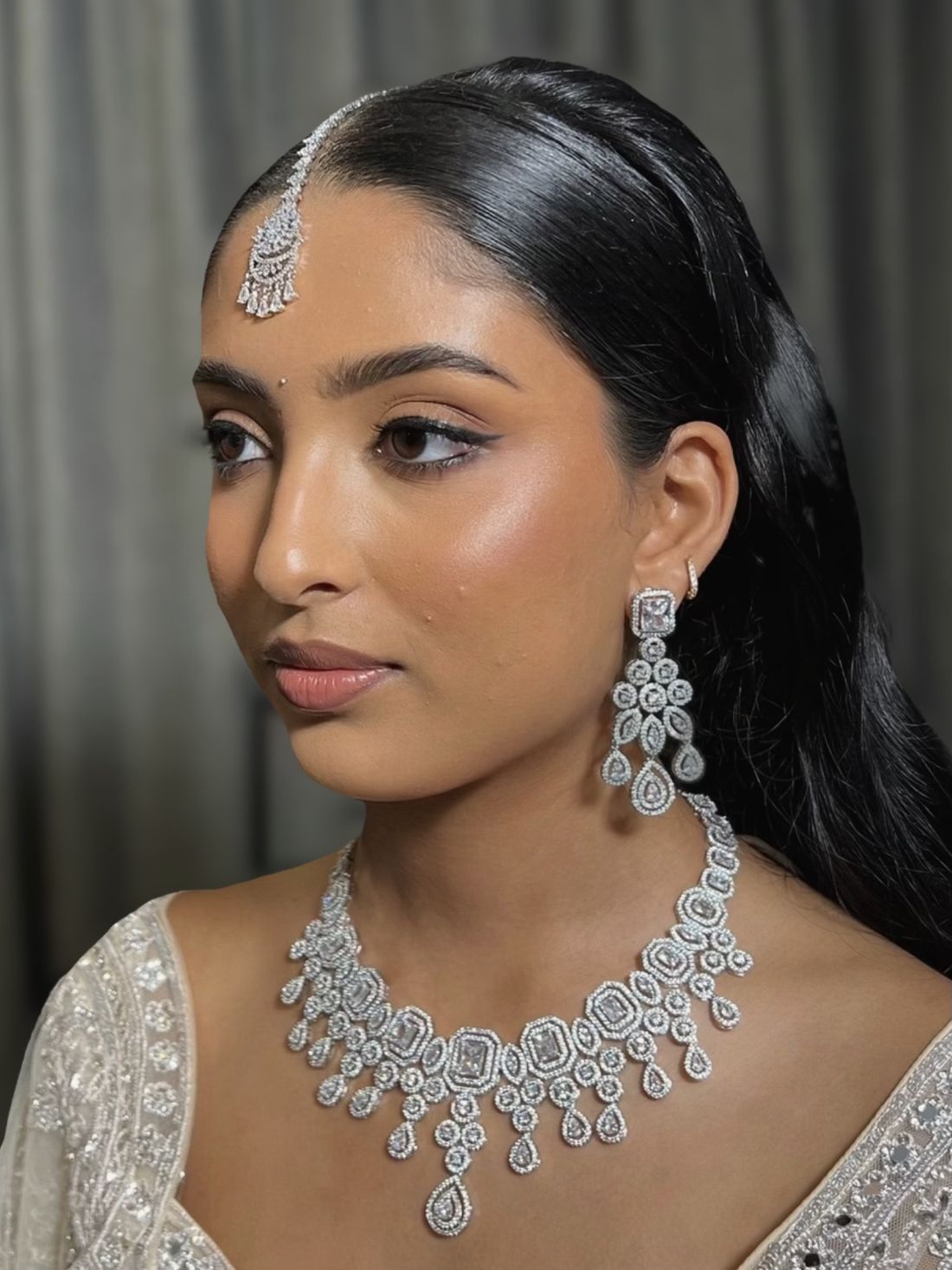 Bride with radiant skin, winged liner and statement silver jewellery